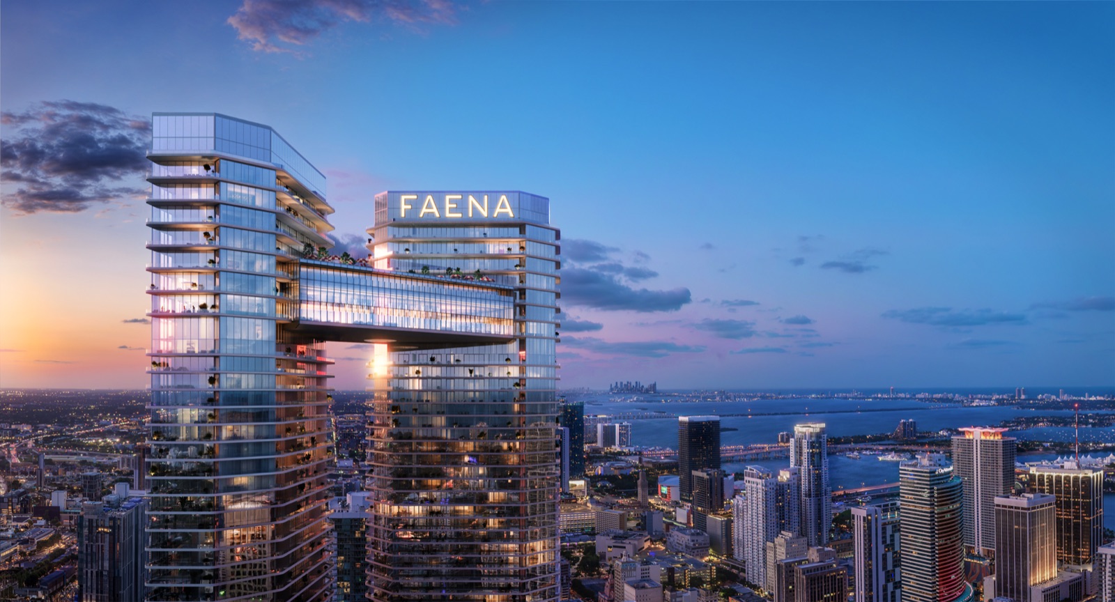 Faena Residences Miami in context along the Miami River — twin riverfront towers connected by the Sky Bridge, anchoring the 14-acre Faena District Miami River.